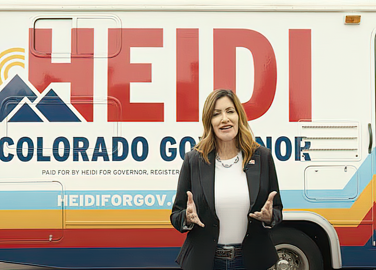 Campaign ad: Watch Polis’s famed tennis shoes literally step in it